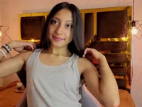 A brunette girl with soft, radiant skin, a slim body that moves with grace and energy. Her black, straight, shiny hair falls in soft waves over her shoulders, highlighting her lively face. She has a warm and contagious smile that lights up her expression and reflects her cheerful and laughing personality. Her attitude is determined and confident, always with a spark of confidence that is noticeable in her bearing and the way she interacts with others. She has a lively look that shows her enthusiasm for life, leaving an impression of freshness and positivity wherever she goes.